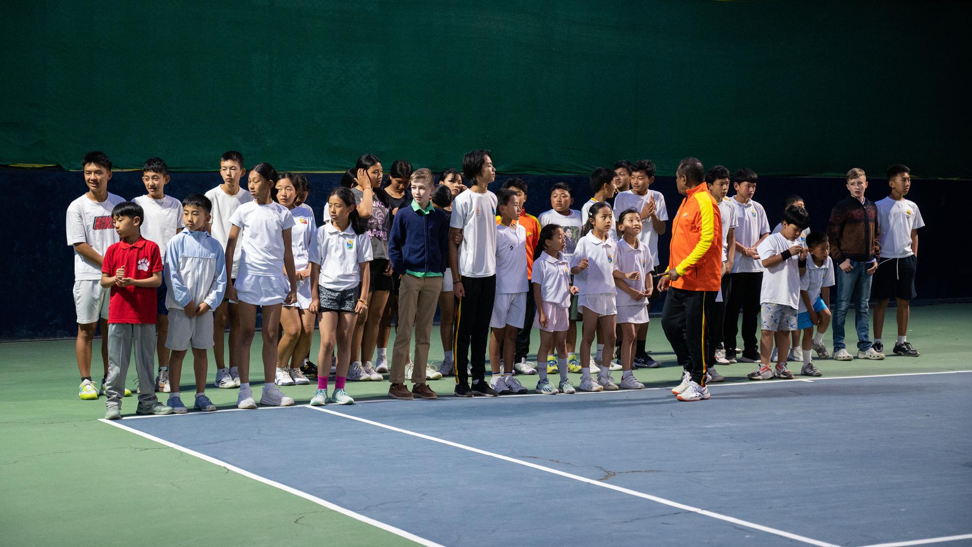 The full group of players and coaches at the junior championship