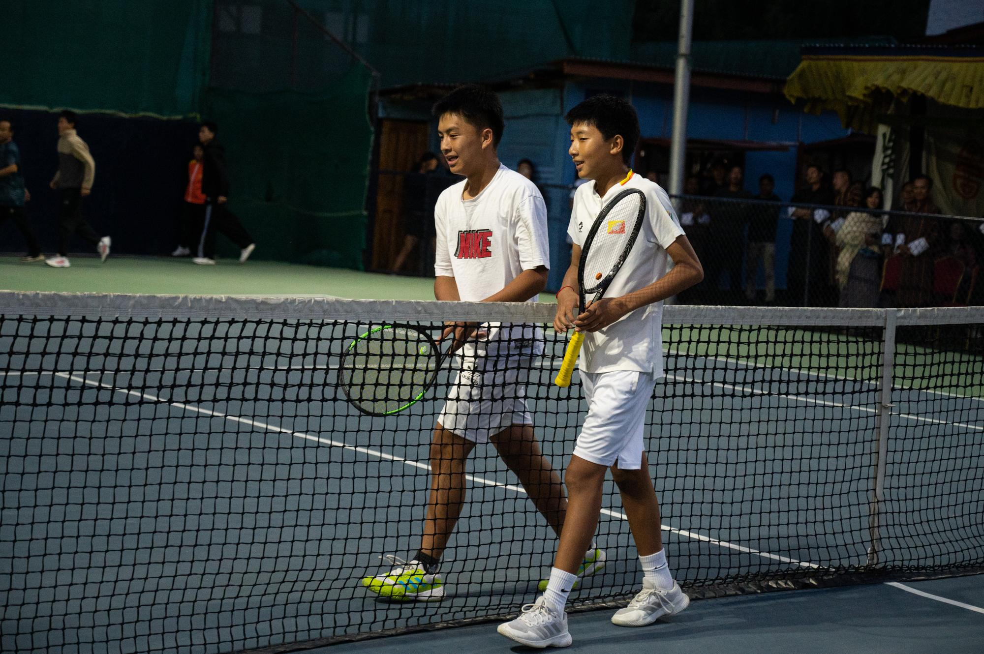 Adults playing doubles on the courts at Changlimithang